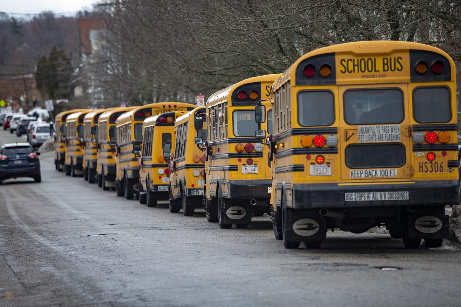 School buses lined up outside of New Mission High School in Hyde Park awaiting students prior to school release. (Jesse Costa/WBUR)