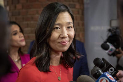 Mayor Michelle Wu talks with reporters at the First Annual Dominican Independence Day Breakfast in Boston. (Robin Lubbock/WBUR)