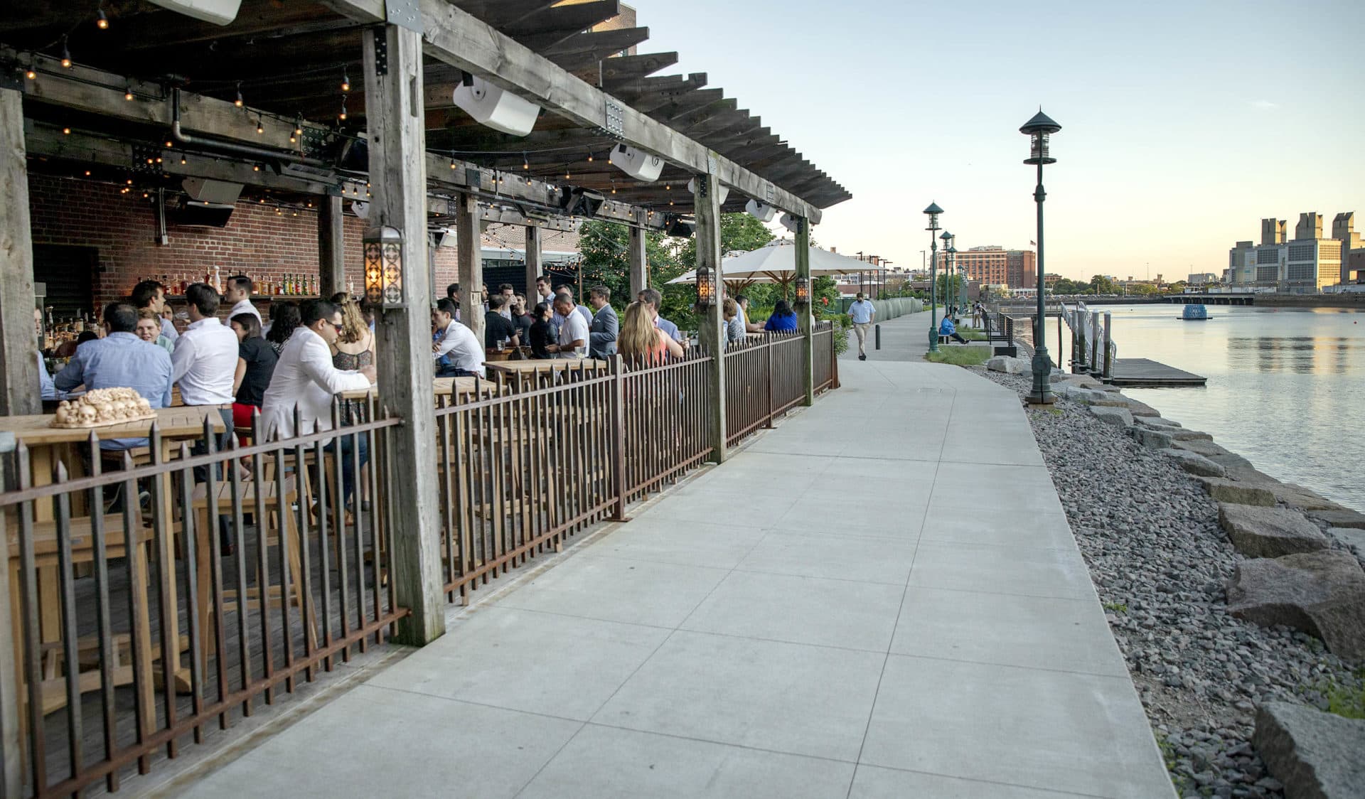 Customers sit at Lolita's bar by the Fort Point Channel in the early evening. (Robin Lubbock/WBUR)