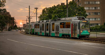 A Green Line MBTA train makes its way along Commonwealth Ave. in Brighton. (Robin Lubbock/WBUR)