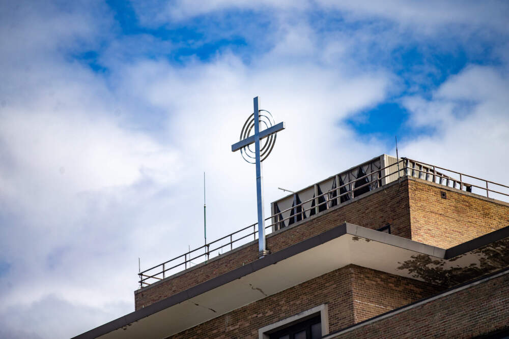 The crucifix atop Carney Hospital in Dorchester. (Jesse Costa/WBUR)