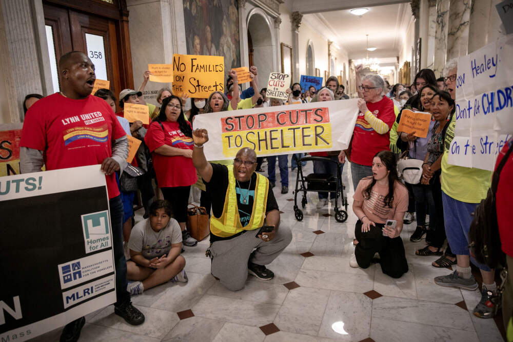 Protesters inside the Massachusetts State House call on Gov. Maura Healey to reconsider new restrictions to the state's family shelter system. (Robin Lubbock/WBUR)