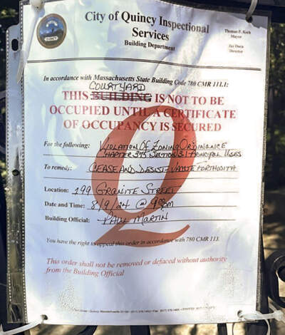 A cease and desist notice was posted on the gate of a Lutheran Church in Quincy after the church allowed Haitian migrants to sleep in tents on its grounds. (Photo courtesy of the church)