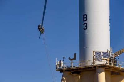 Technicians of the Block Island Wind Farm Support Team repair a crack in the blade of one of the wind turbines. (Jesse Costa/WBUR)