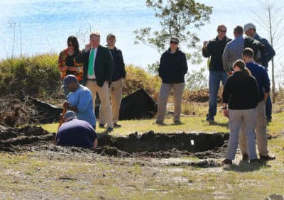 The FBI, investigators and excavation personnel at the scene of a lot in Orlando where an excavator dug up a section of the yard in hopes of finding the stolen Gardner Museum artwork. (John Tlumacki/Boston Globe)