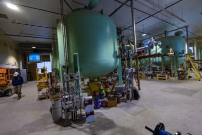 Littleton Electric Light and Water Department workers inside a new water treatment facility that will remove PFAS chemical compounds from the water supply. (Jesse Costa/WBUR)