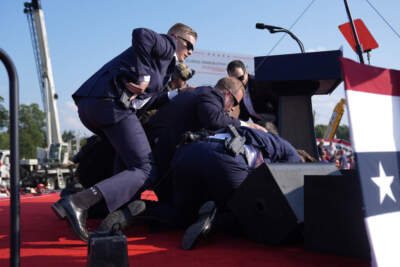 Republican presidential candidate former President Donald Trump is covered by U.S. Secret Service agents at a campaign rally, Saturday, July 13, 2024, in Butler, Pa. (Evan Vucci/AP)