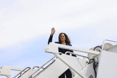 Vice President Kamala Harris waves while boarding Air Force Two as she departs on campaign travel to Milwaukee, Wisc., Tuesday, July 23, 2024 at Andrews Air Force Base, Md. (Kevin Mohatt/Pool via AP)