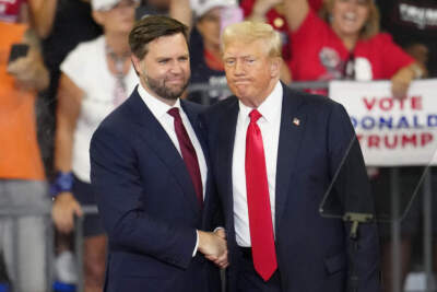 Sen. JD Vance, R-Ohio, left, former President Donald Trump, shake hands at a campaign rally at Georgia State University in Atlanta, Saturday, Aug. 3, 2024. (Ben Gray/AP)