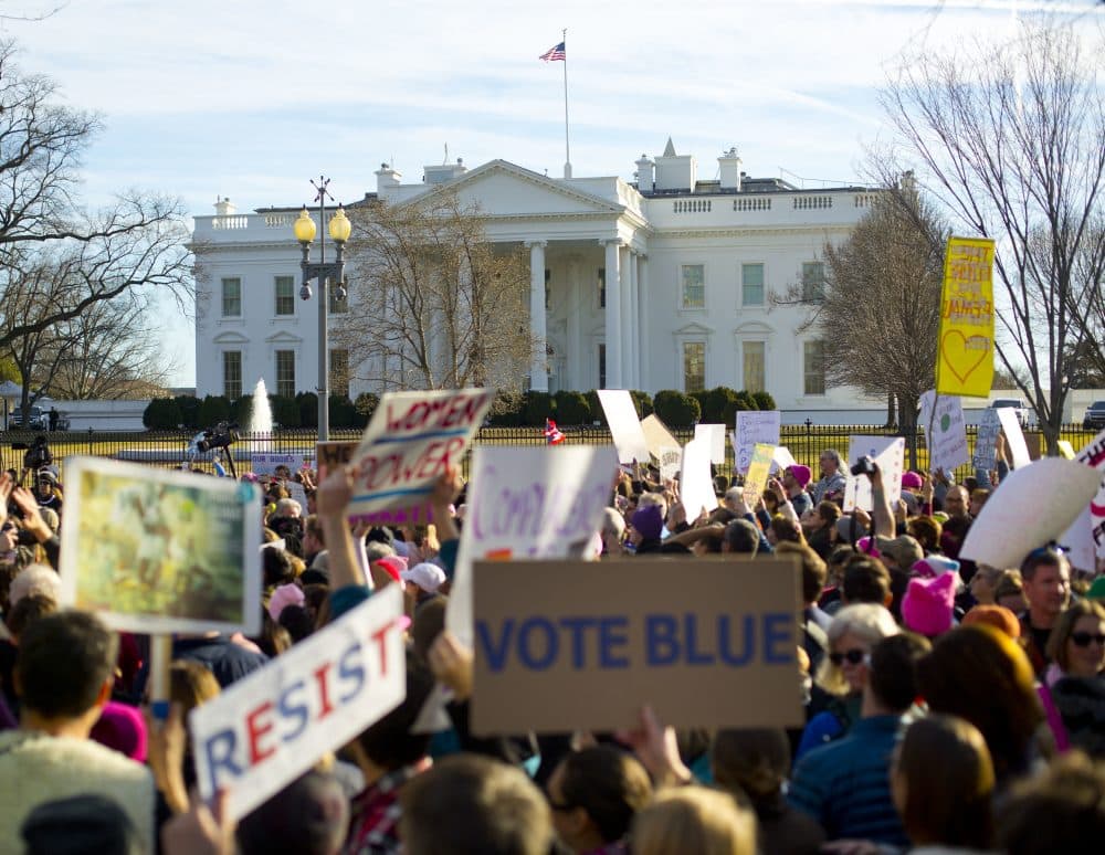 Women's March demonstrators walk past the White House in Washington, Saturday, Jan. 20, 2018. On the anniversary of President Donald Trump's inauguration, people participating in rallies and marches in the U.S. and around the world Saturday denounced his views on immigration, abortion, LGBT rights, women's rights and more. (Pablo Martinez Monsivais/AP)