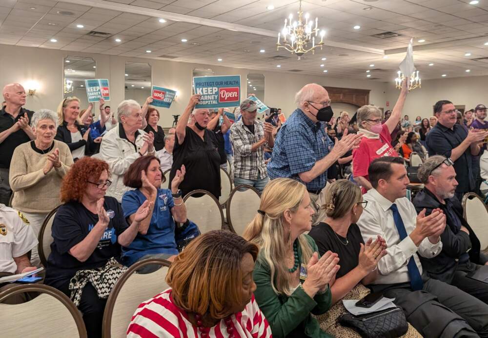 A crowd of hundreds packed a public meeting to decry the planned closure of Steward's Carney Hospital (Priyanka Dayal McCluskey/WBUR)