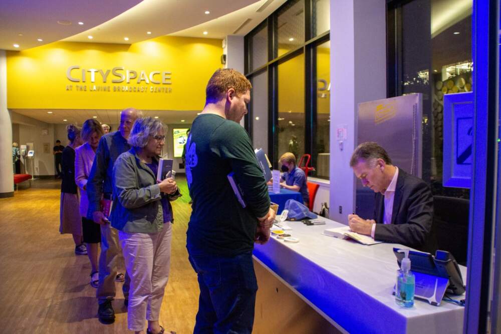 CitySpace guests wait for NPR Morning Edition host Steve Inskeep to sign their books. (GT Nguyen / WBUR)