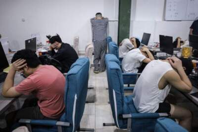 A police raid on suspicion of running an online love scam syndicate in Indonesia. (STR/AFP/Getty)