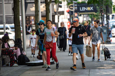 People carry from frozen drinks as they walk down Boylston Street during a heatwave in Boston, Massachusetts, on June 19, 2024. (Joseph Prezioso/AFP via Getty Images)