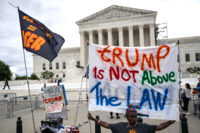 People hold anti-Trump signs in front of the US Supreme Court on July 1, 2024, in Washington, DC. (DREW ANGERER/AFP via Getty Images)