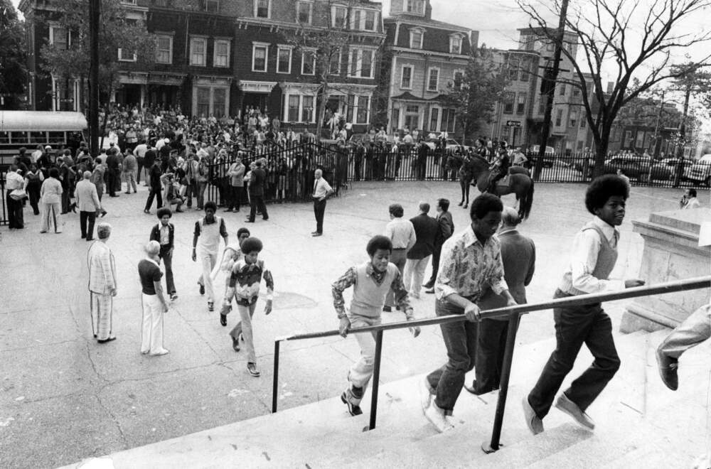 Students enter a school in South Boston on the first day of federally imposed desegregation on Sep. 12, 1974. (Joe Dennehy/The Boston Globe via Getty Images)