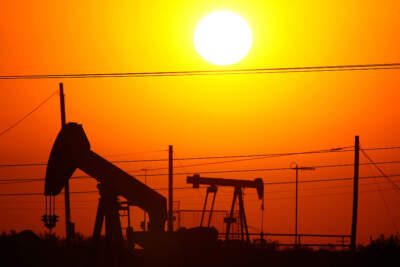 Oil rigs just south of town extract crude for Chevron at sunrise in Taft, California. (David McNew/Getty Images)