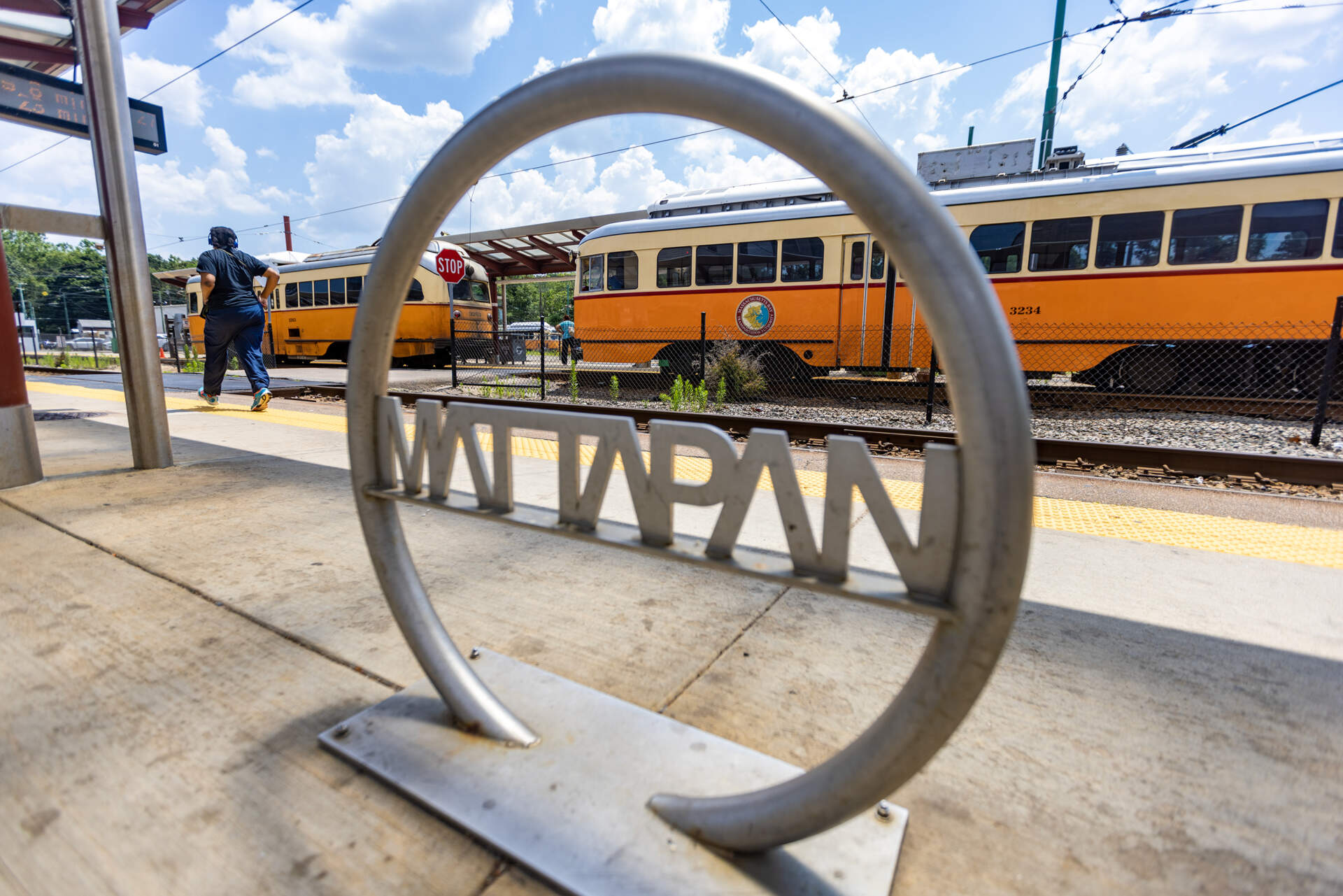 A woman runs to catch the trolley at the MBTA Mattapan Station. (Jesse Costa/WBUR)